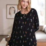 Close up of a model looking to the side with while wearing the Long Sleeve Adult Sleep Bag Walker in Midnight Wildflower