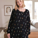 Close up of a woman smiling while she models the Long Sleeve Adult Sleep Bag Walker in Midnight Wildflower