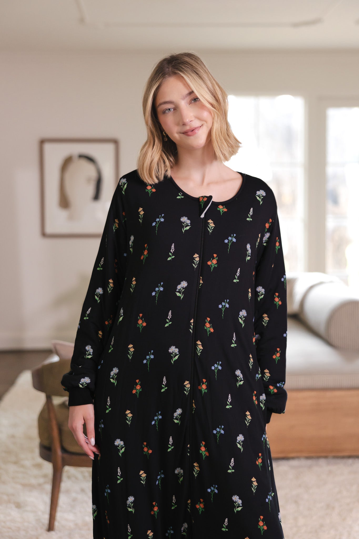 Close up of a woman smiling while she models the Long Sleeve Adult Sleep Bag Walker in Midnight Wildflower
