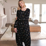 Blonde woman with arms crossed across her front while modeling the Long Sleeve Adult Sleep Bag Walker in Midnight Wildflower 