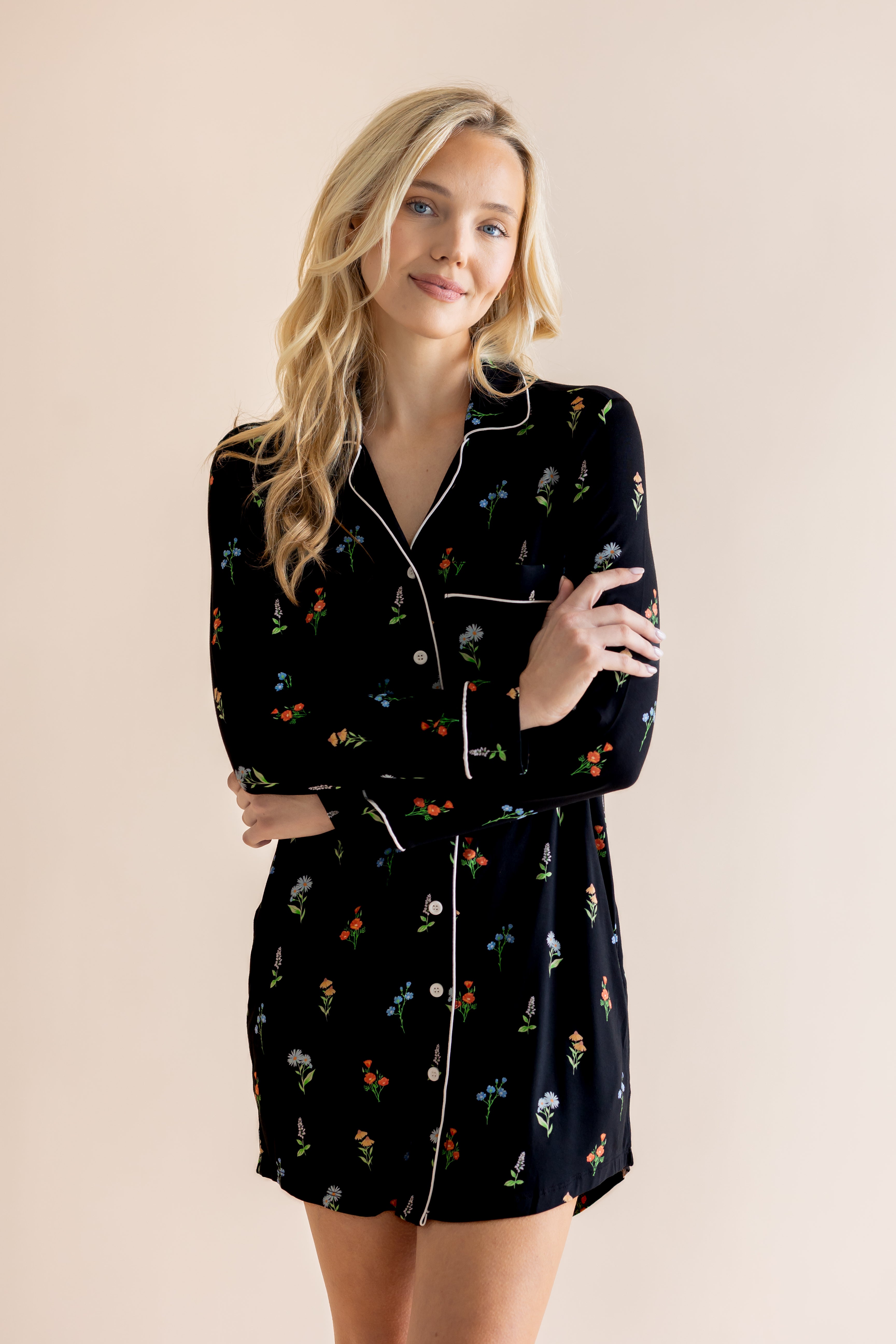 Model smiling in Long Sleeve Women’s Nightshirt in Midnight Wildflower print on a beige background