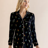 Model posing in Long Sleeve Women’s Nightshirt in Midnight Wildflower print on a beige background