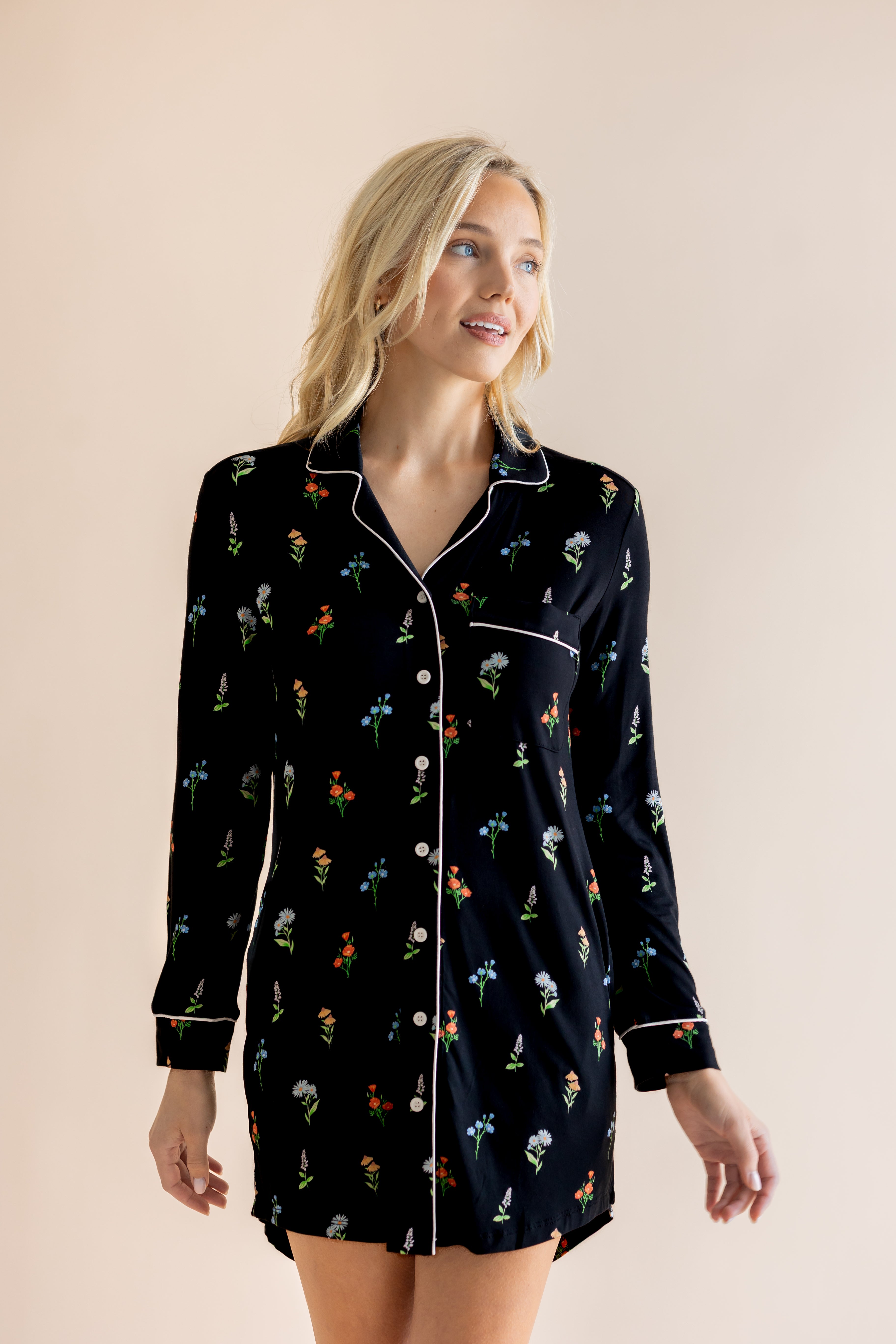 Model posing in Long Sleeve Women’s Nightshirt in Midnight Wildflower print on a beige background