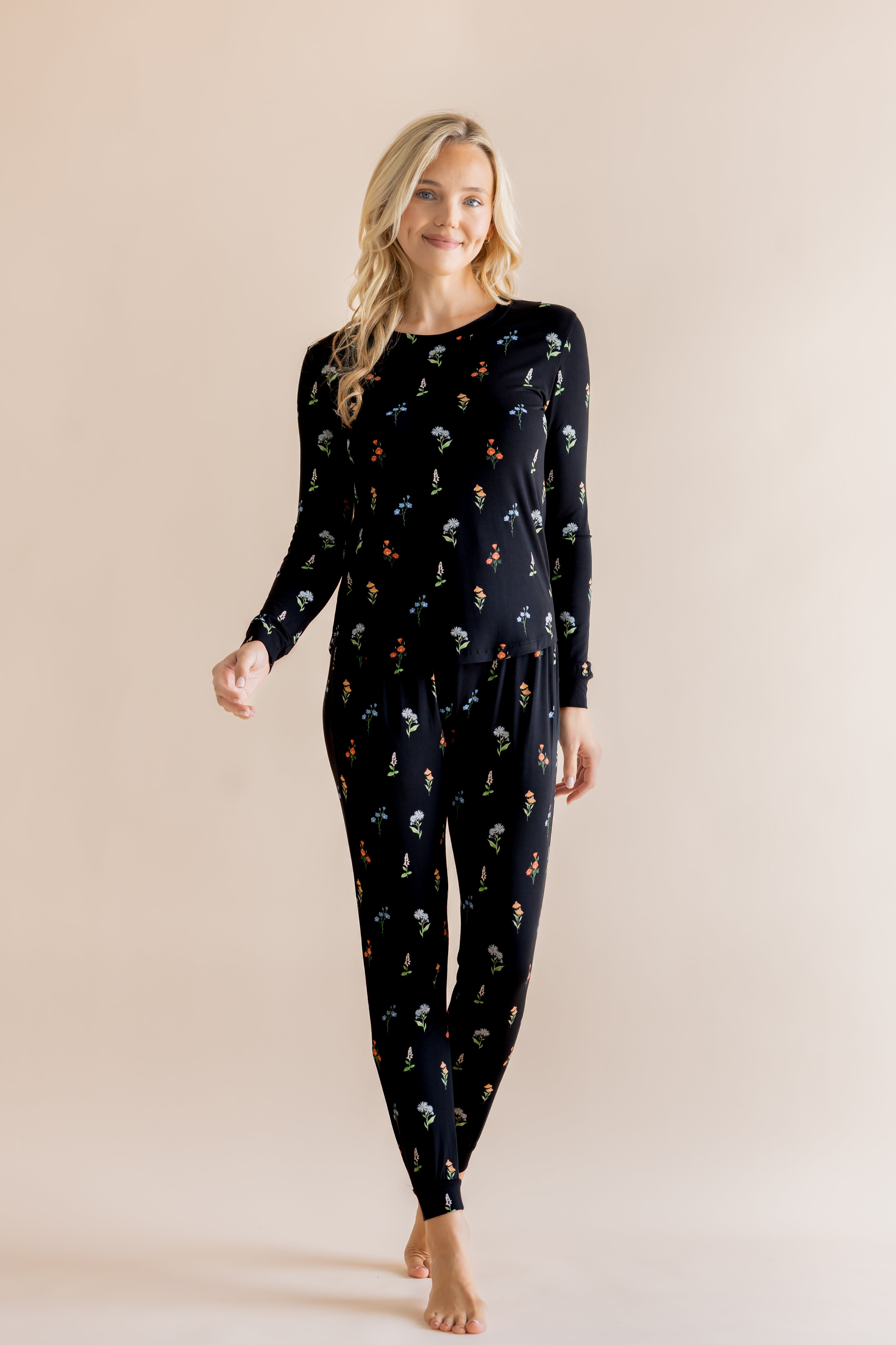 Model wearing Women's Jogger Pajama Set in Midnight Wildflower print on beige background ::: Model is 5'9" wearing size XS ///