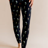 Model showing the Women's Jogger Pajama in Midnight Wildflower print on beige background