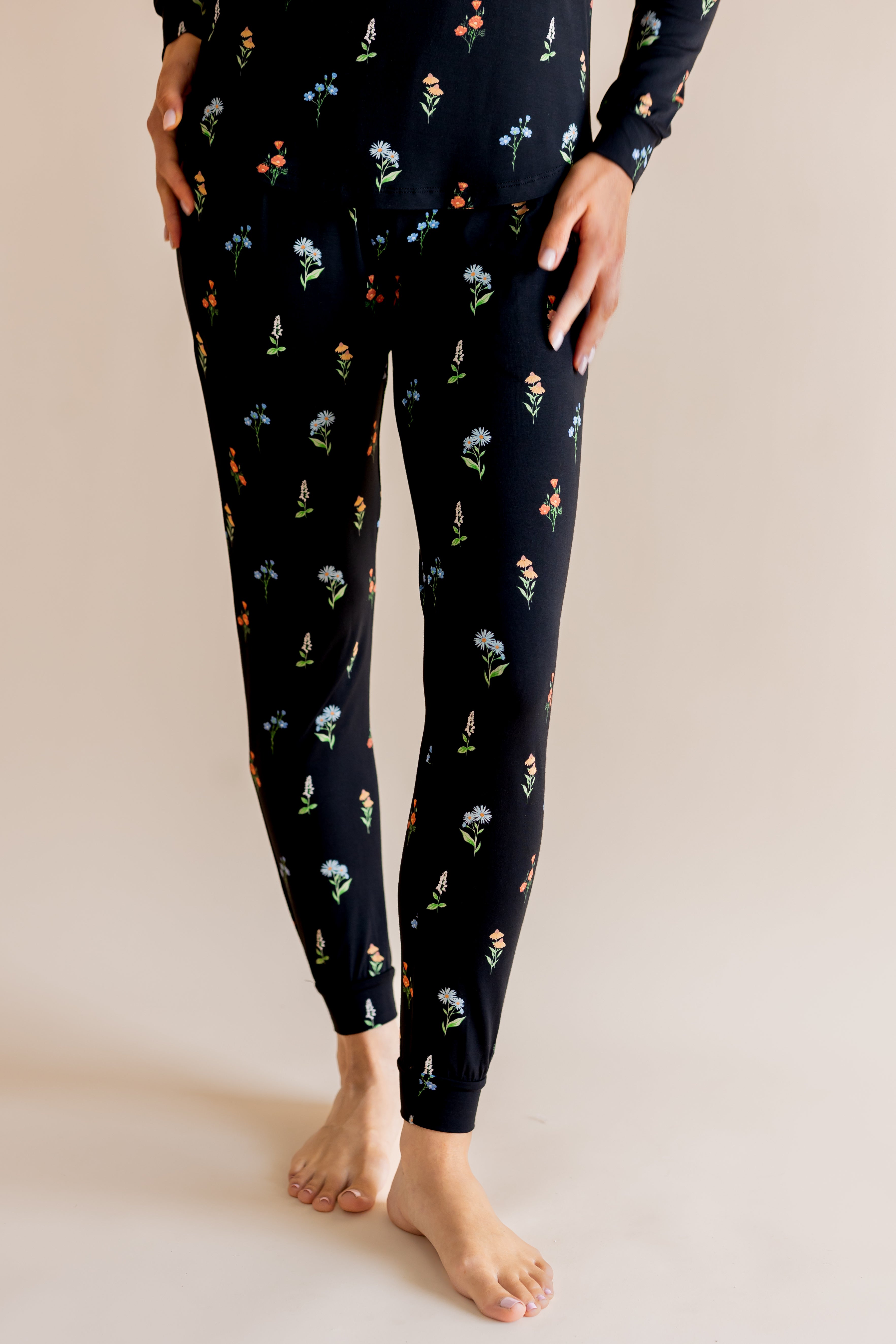 Model showing the Women's Jogger Pajama in Midnight Wildflower print on beige background