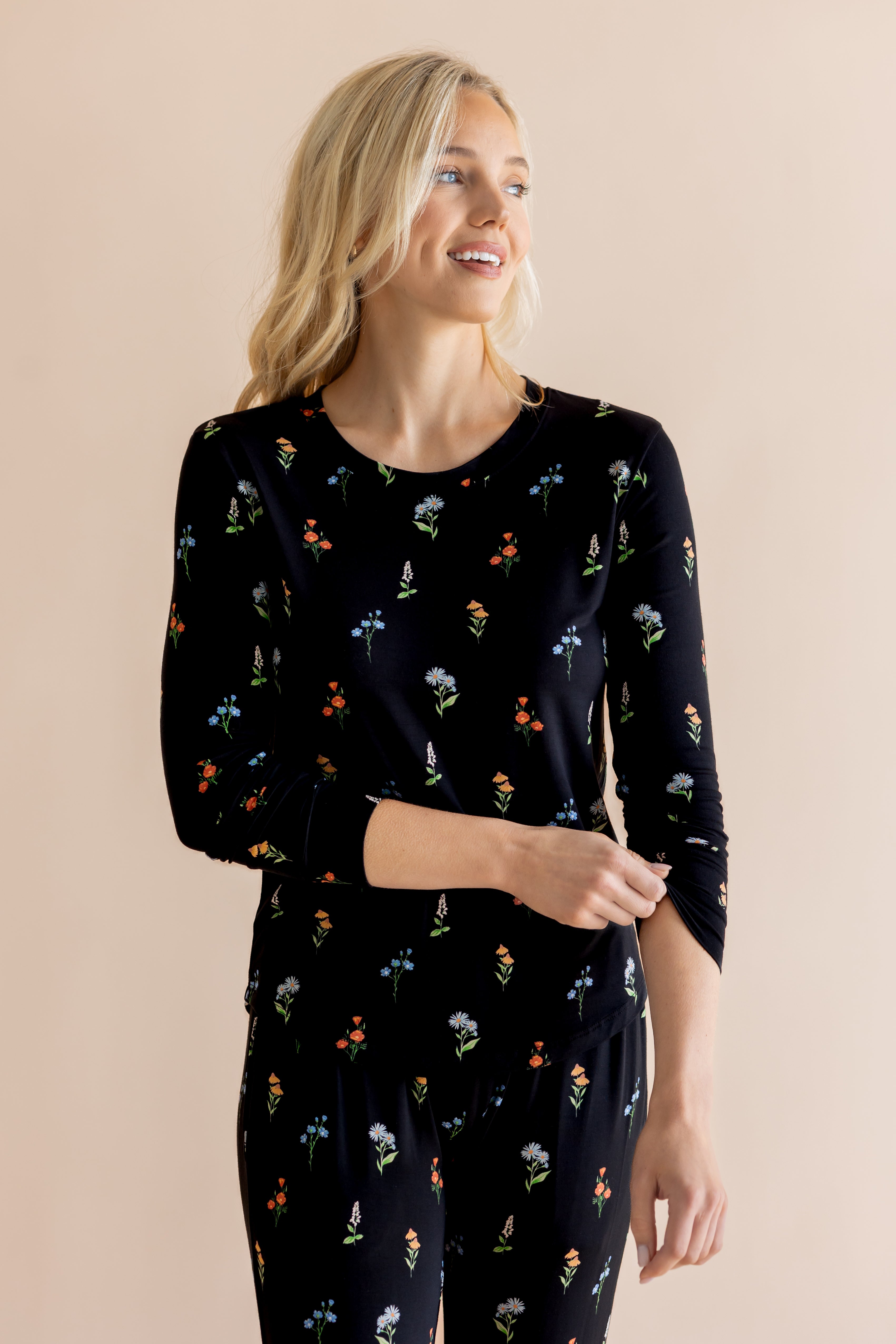 Model smiling in Women's Jogger Pajama Set in Midnight Wildflower print on beige background