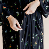Model showcasing the front of Women’s Kimono Robe in Midnight Wildflower print on a beige background
