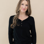 Woman wearing Women's Long Sleeve Henley Tee in Midnight and jeans