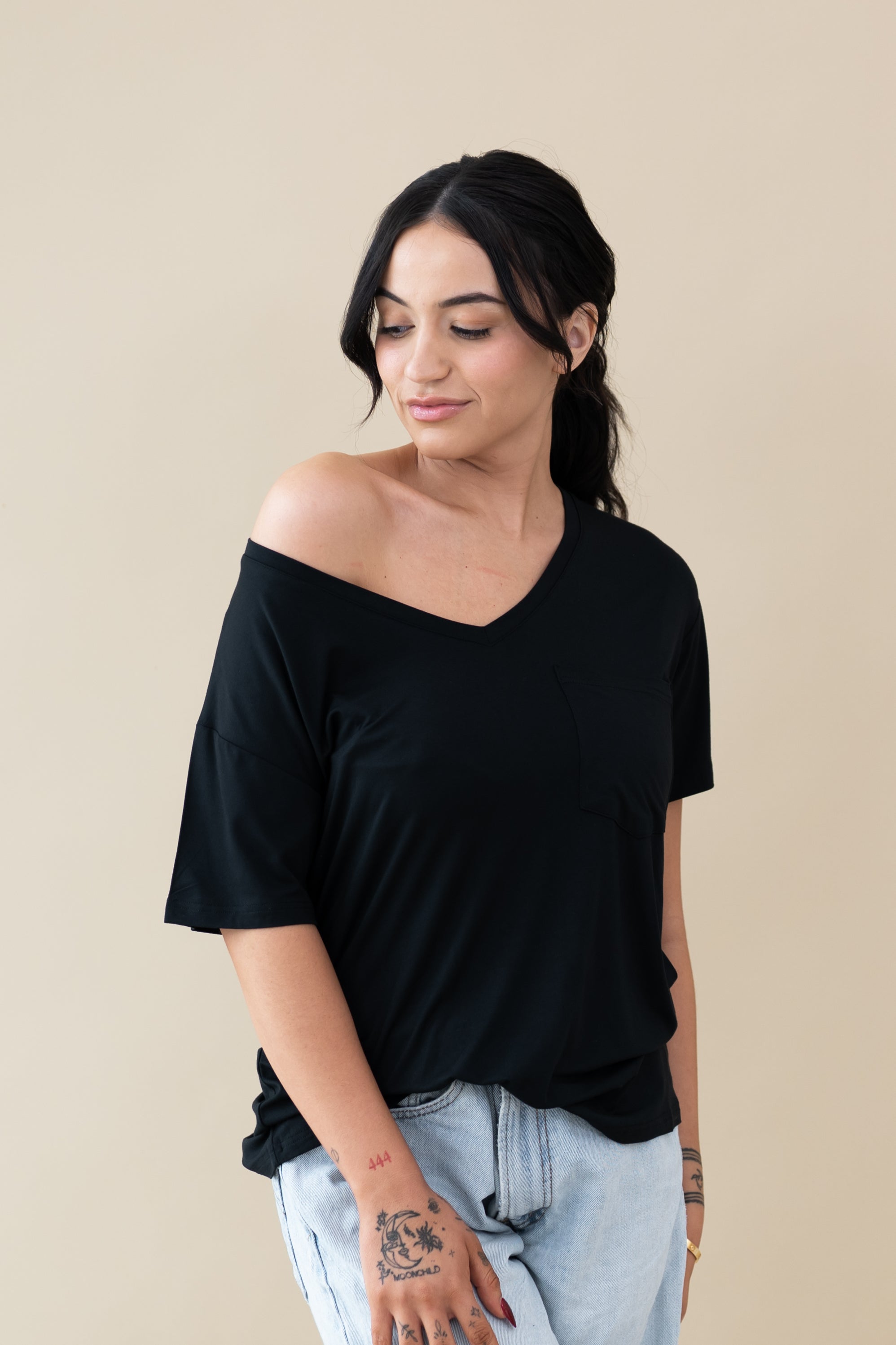 Female wearing the Women’s Relaxed Fit V-Neck in Midnight off the shoulder