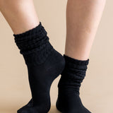 Black socks worn on a beige background