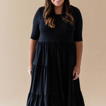 Female model wearing the Women’s Tiered Dress in Midnight