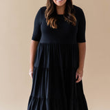 Female model wearing the Women’s Tiered Dress in Midnight