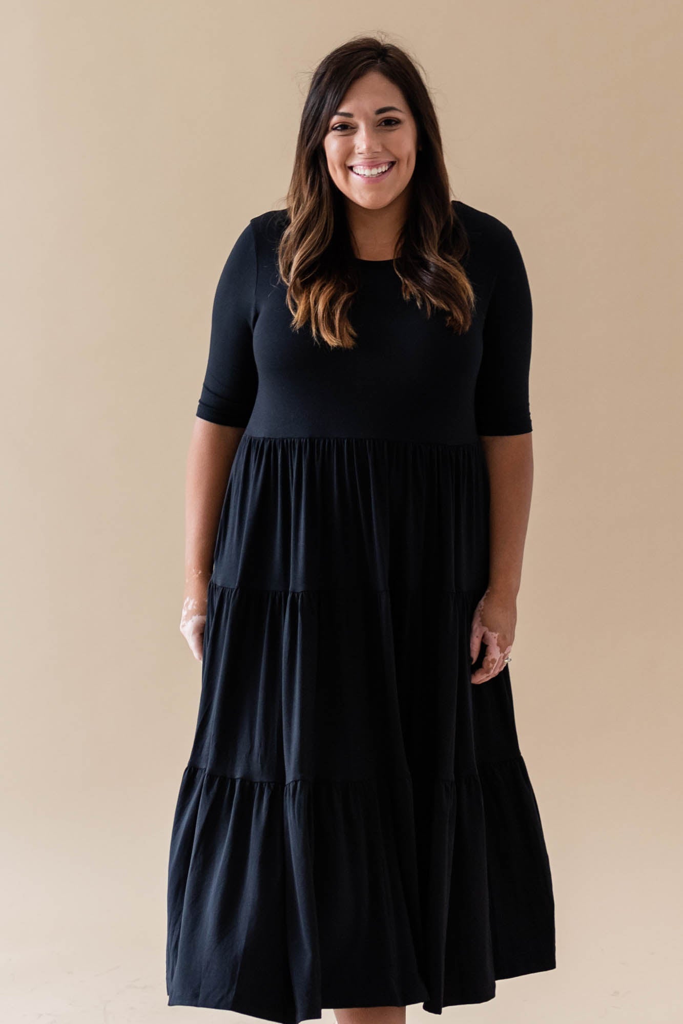 Female model wearing the Women’s Tiered Dress in Midnight