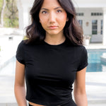 Female standing in front of a pool wearing the Bamboo Flex Baby Tee in Midnight

::: Model is 5'2" wearing size S ///