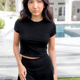 Female modeling the Bamboo Flex Skort in Midnight paired with a matching baby tee
