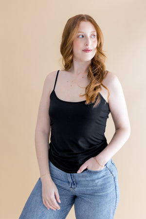 Woman wearing black tank top and jeans ::: Model is 5'7" wearing size M ///
