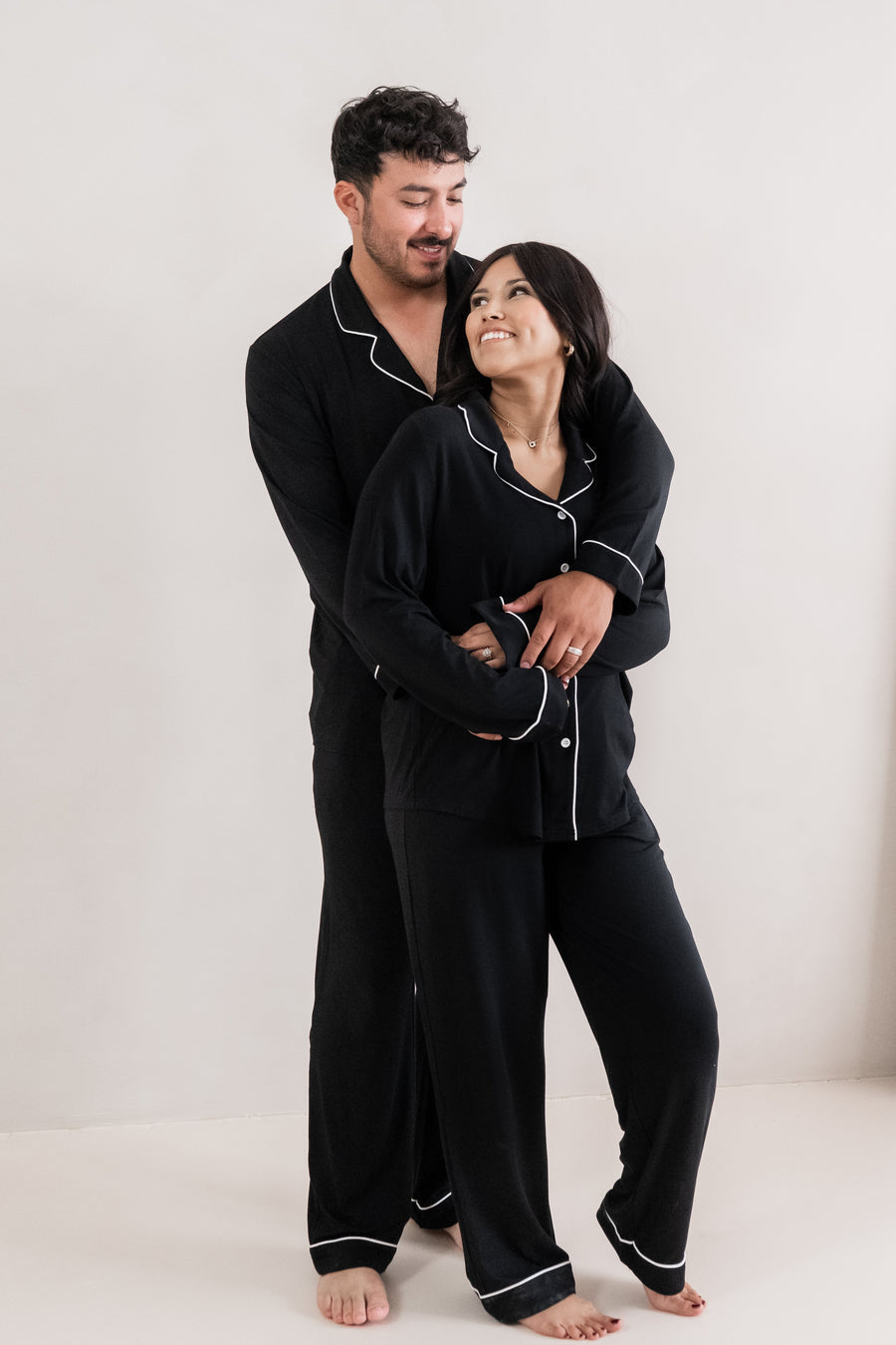 Couple wearing matching Long Sleeve Pajama Sets in Midnight with Cloud Trim
