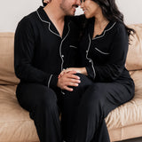 Couple embraced on a couch wearing matching  Long Sleeve Pajama Sets in Midnight