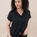 Woman modeling Women’s Short Sleeve Pajama Set in Midnight Leopard looking off to side