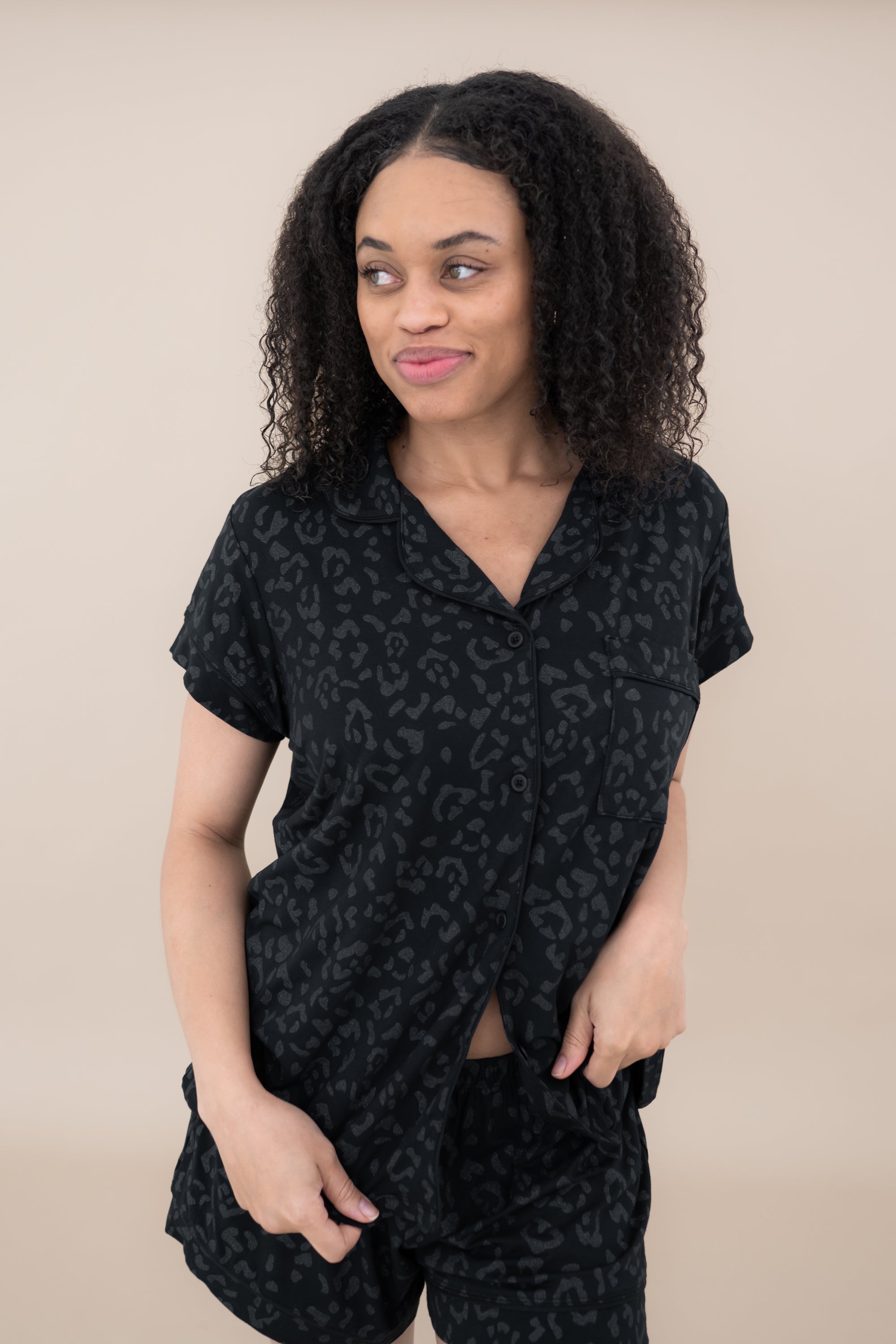 Woman modeling Women’s Short Sleeve Pajama Set in Midnight Leopard looking off to side