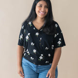 Female model wearing the Women’s Relaxed Fit V-Neck in Big Midnight Magnolia