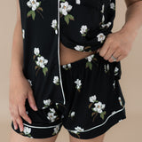 Woman modeling Women’s Short Sleeve Pajama Set in Big Midnight Magnolia. Close up on waistband of shorts.