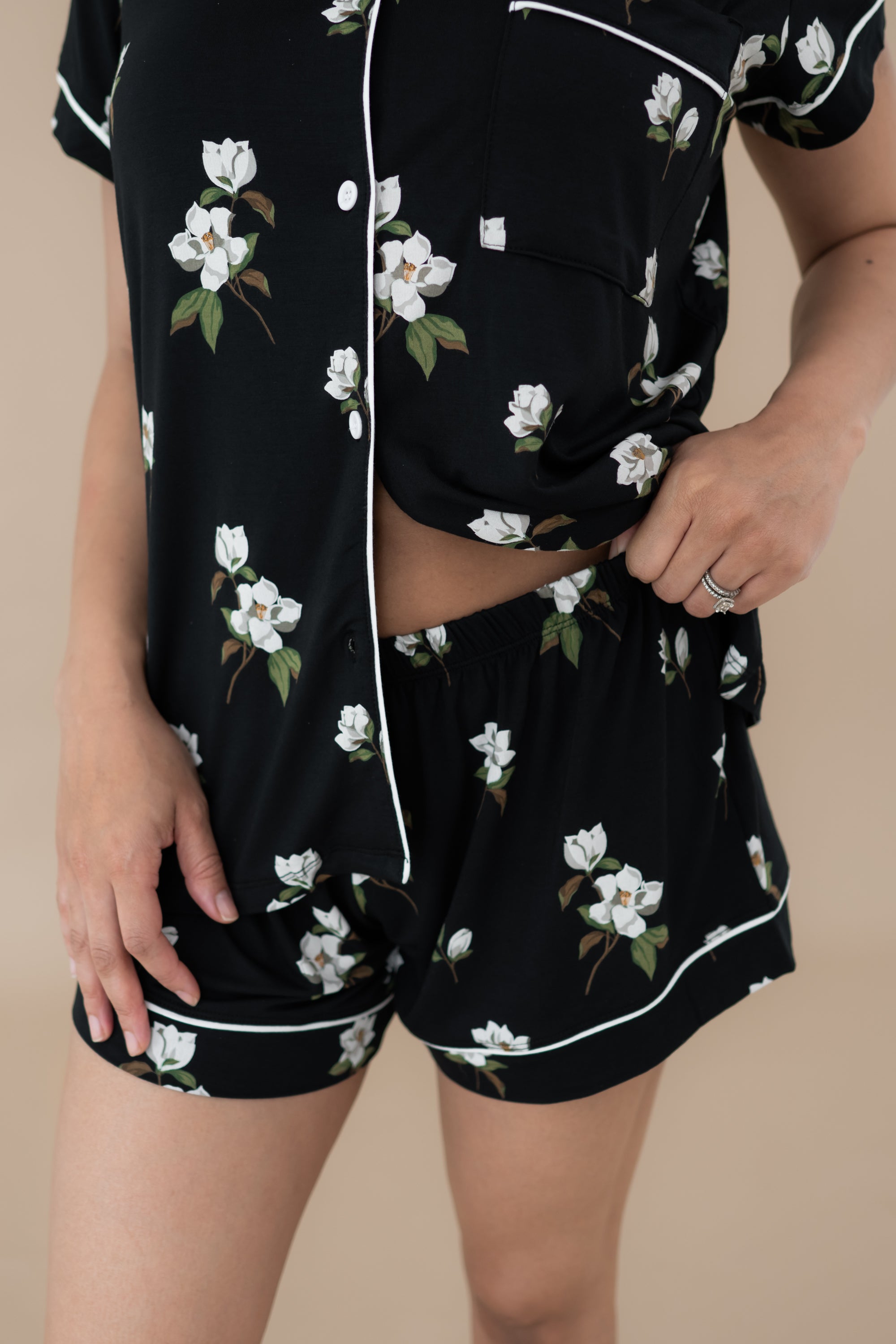 Woman modeling Women’s Short Sleeve Pajama Set in Big Midnight Magnolia. Close up on waistband of shorts.
