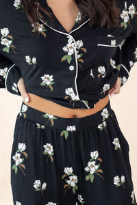 Black floral dress with a close-up of the outfit on a neutral background