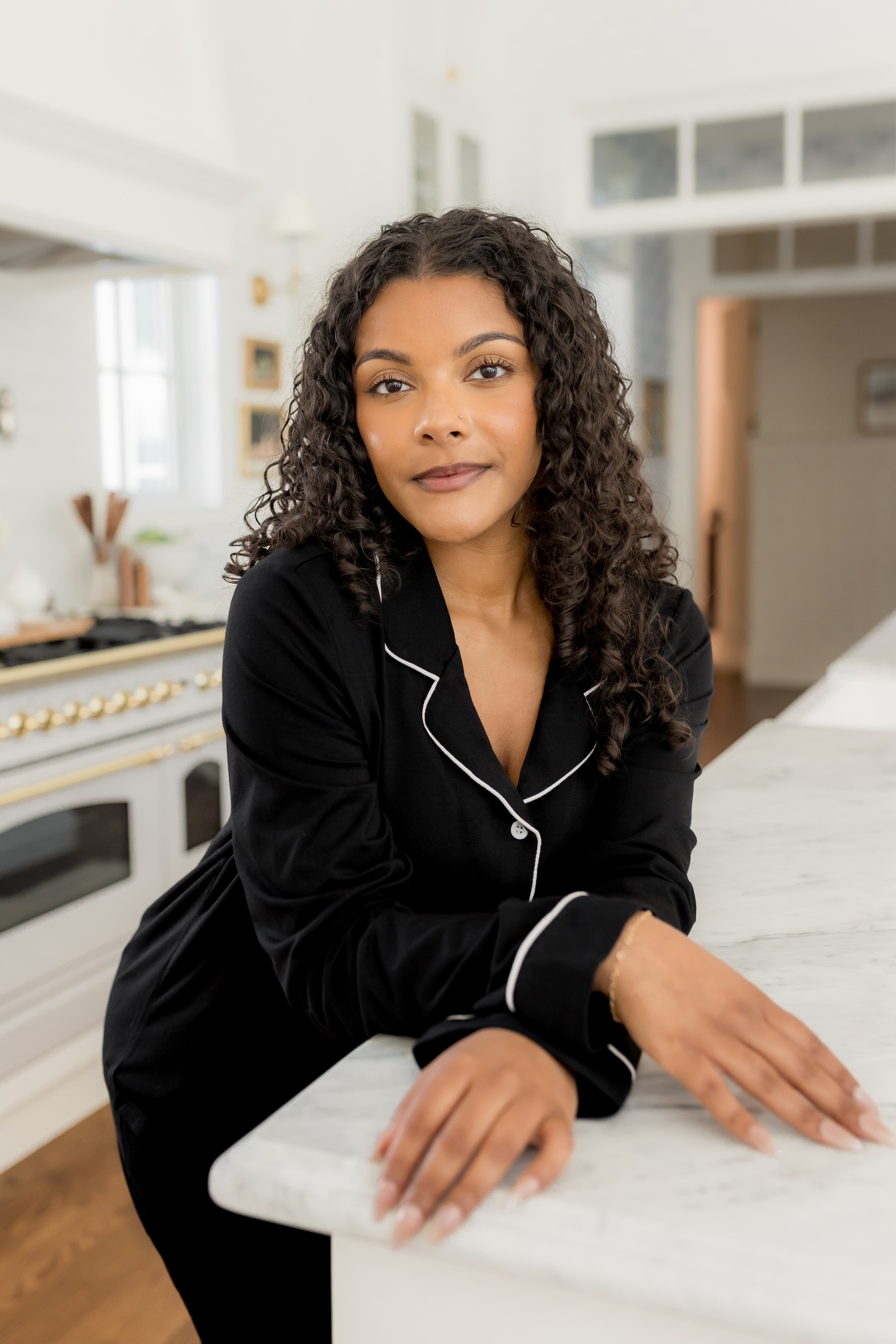Woman in black pajamas in a kitchen 