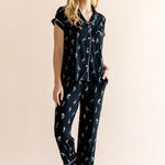 Model posing in Women's Short Sleeve Cropped Pajama Set in Midnight Wildflower print on a beige background ::: Model is 5'9" wearing size XS /// ---1620 1

