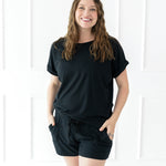 Female modeling the Women's Bamboo Jersey Rollup Sleeve Tee in Midnight paired with Midnight Bamboo Jersey Shorts 