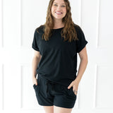Female modeling the Women's Bamboo Jersey Rollup Sleeve Tee in Midnight paired with Midnight Bamboo Jersey Shorts 