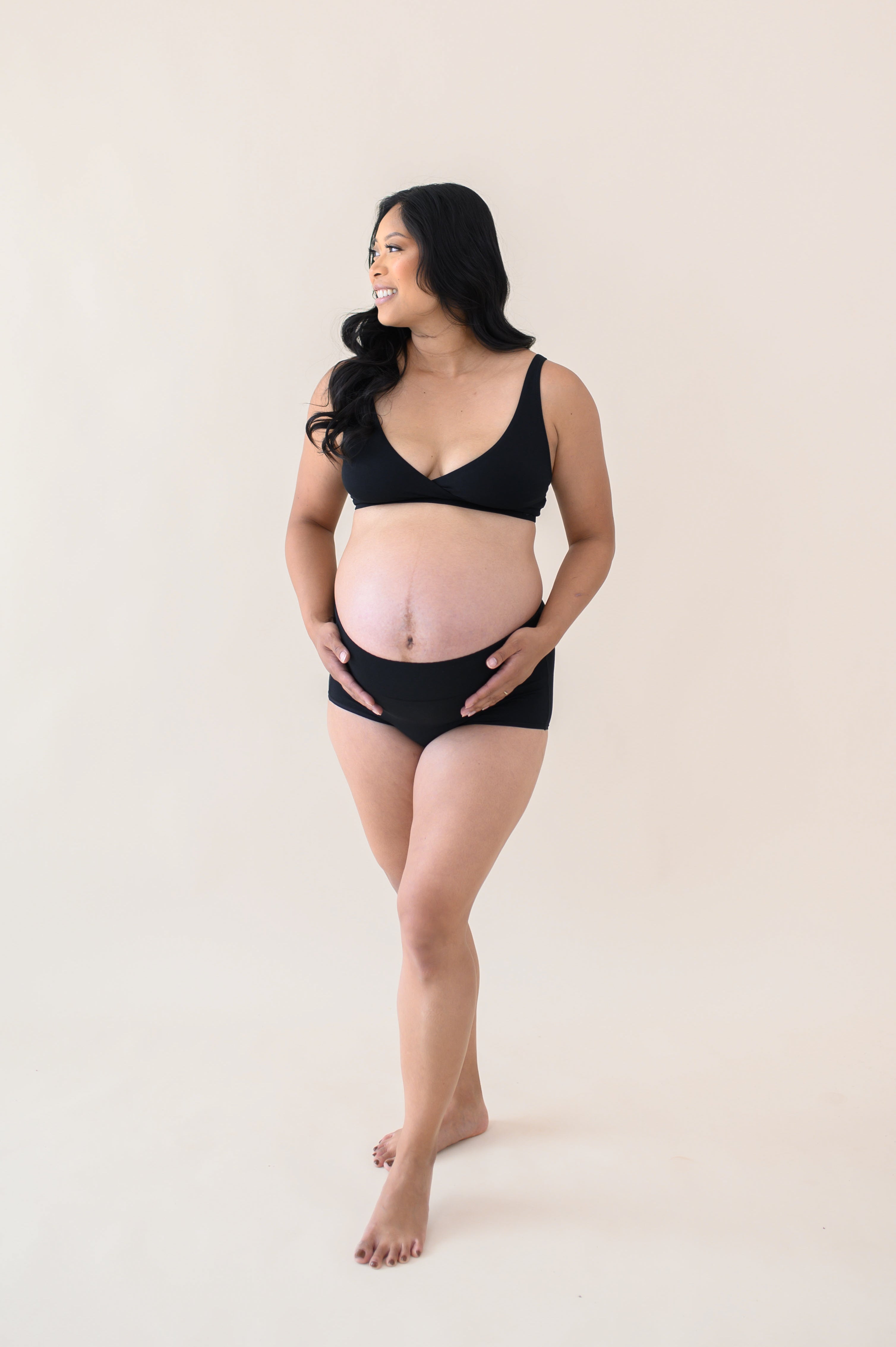 Woman modeling Women's High-Waisted Brief in Midnight with cross front bralette