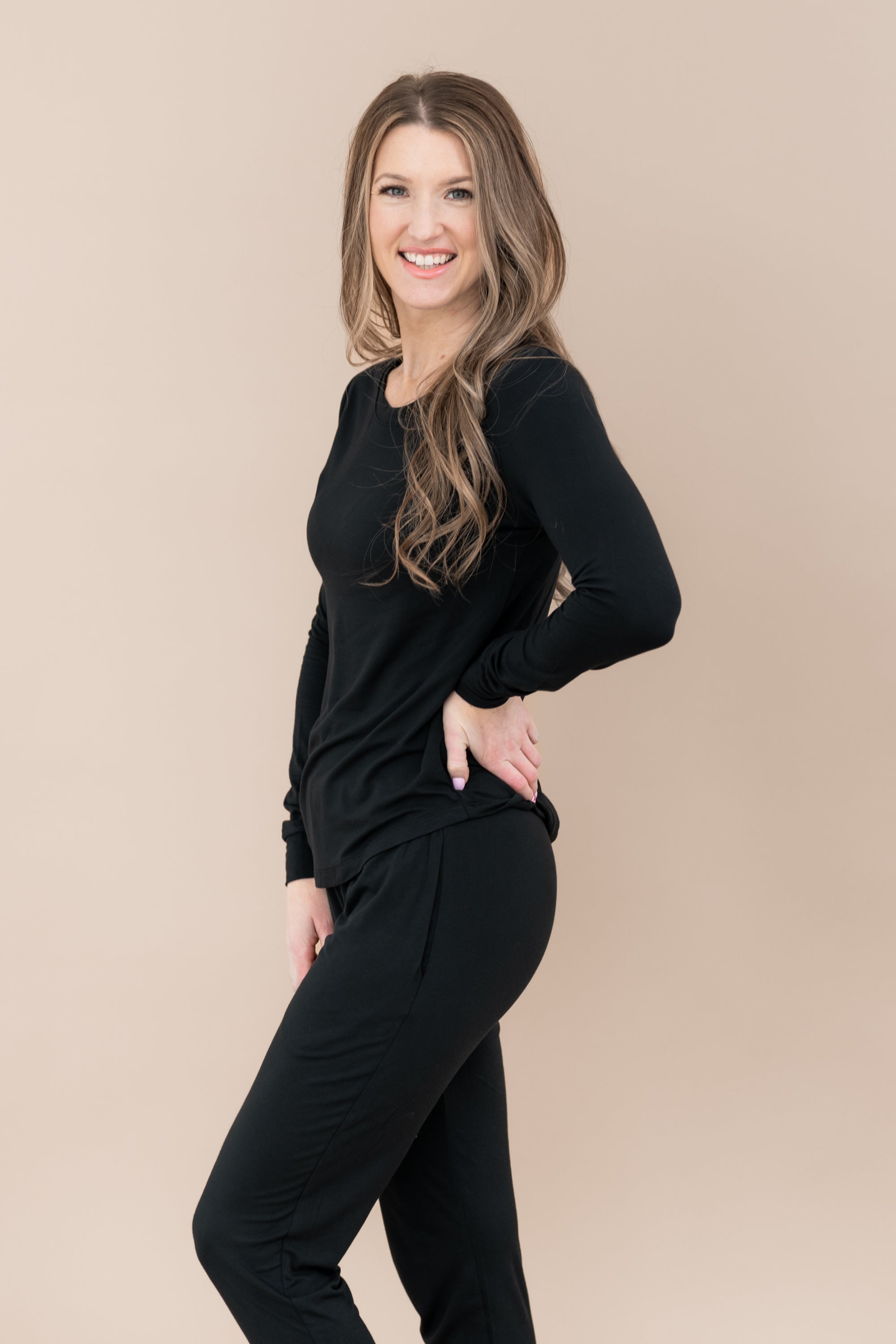 Model wearing Midnight Jogger Pajama set showing off the side of the set with pockets