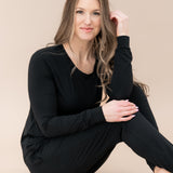 Sitting model wearing the Women's Jogger Pajama Set in Midnight