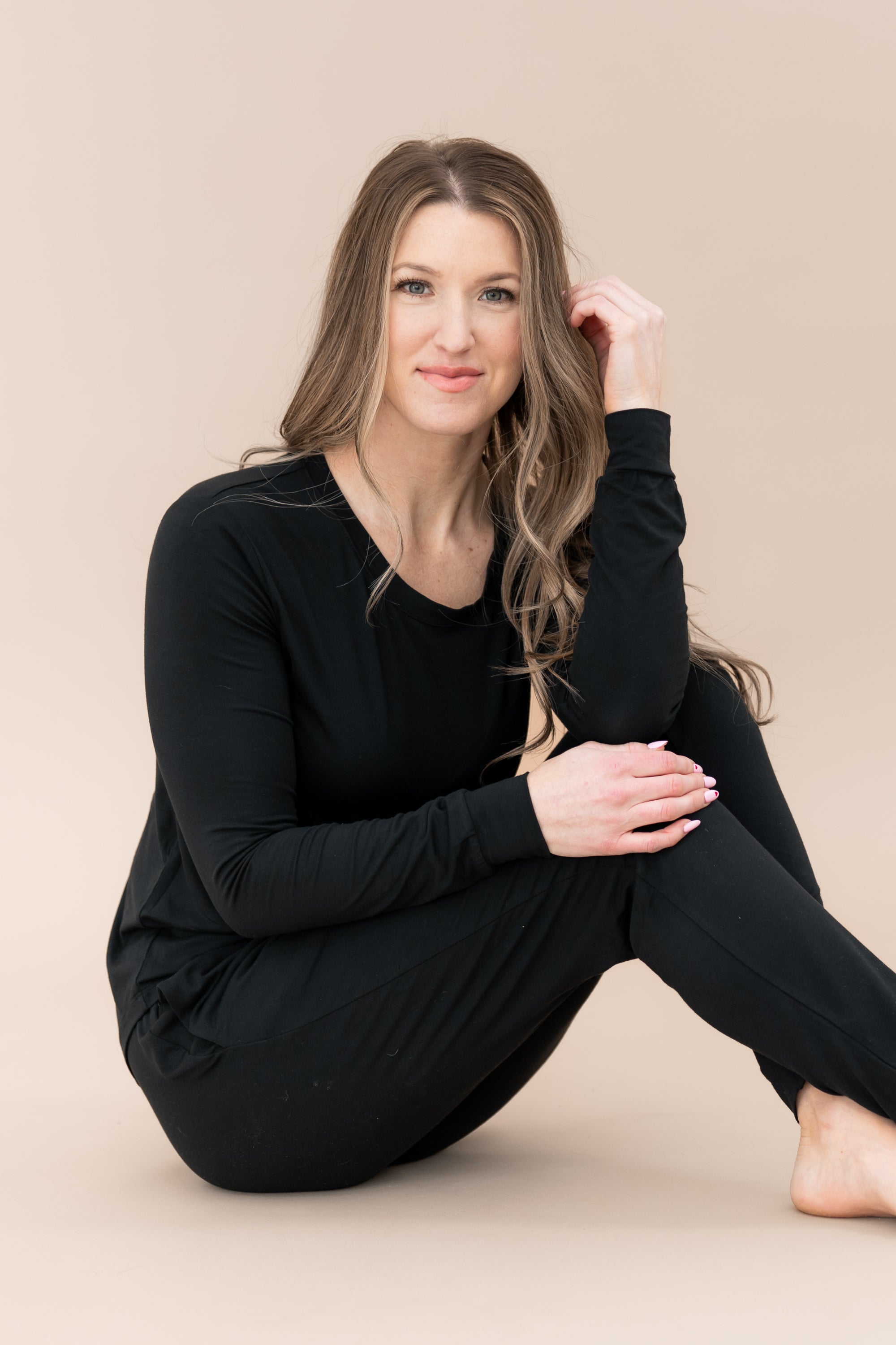 Sitting model wearing the Women's Jogger Pajama Set in Midnight