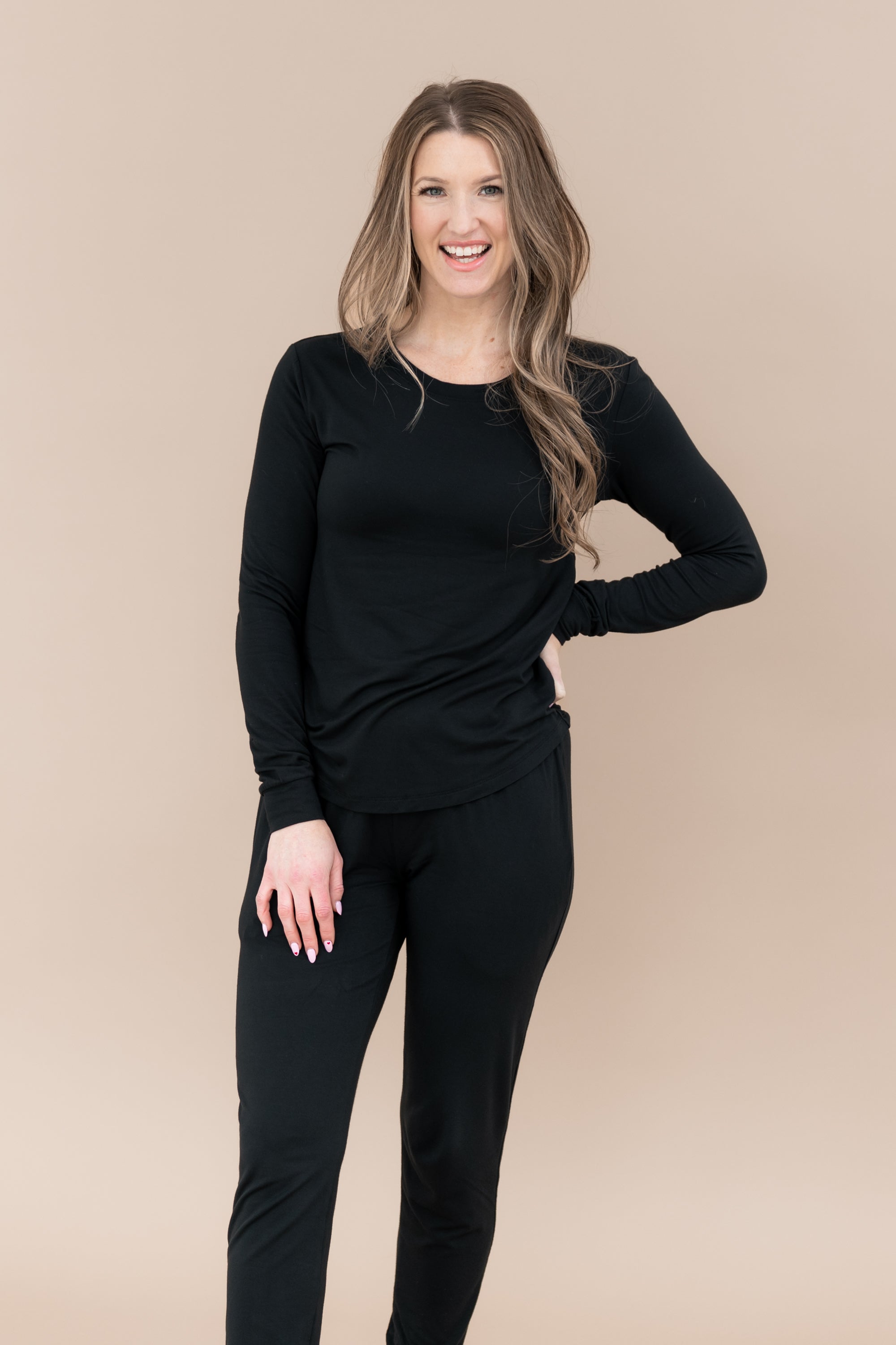 Smiling model wearing the Women's Jogger Pajama Set in Midnight