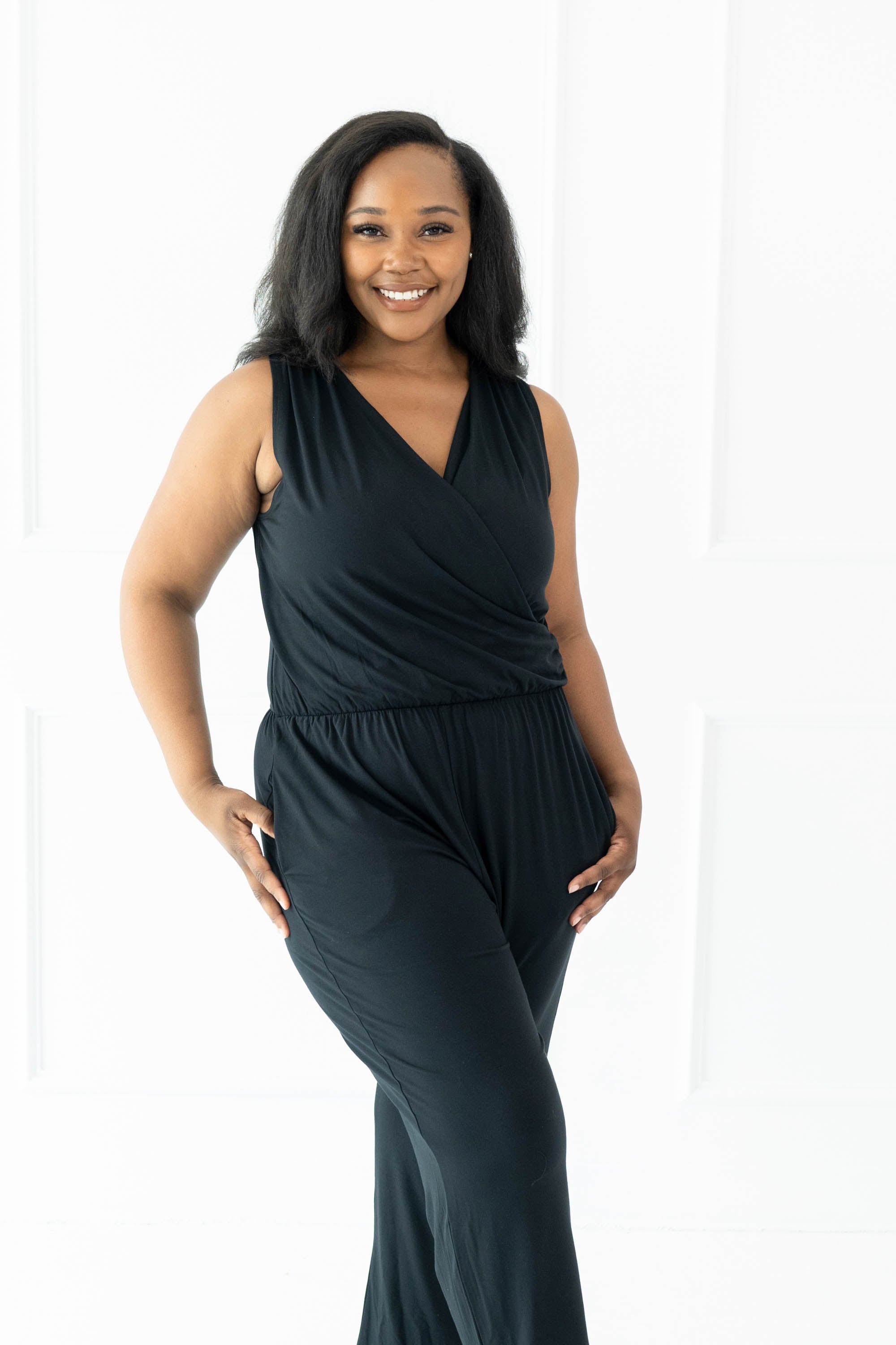 Smiling model wearing the Women's Jumpsuit in Midnight