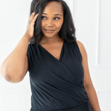 Model wearing the Women's Jumpsuit in Midnight with one hand in hair