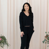 Female model wearing the Women's Ribbed Long Sleeve Crop Top in Midnight paired with Midnight Joggers Pants