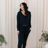 Model wearing the Women's Ribbed Long Sleeve Crop Top in Midnight and Midnight Jogger Pants