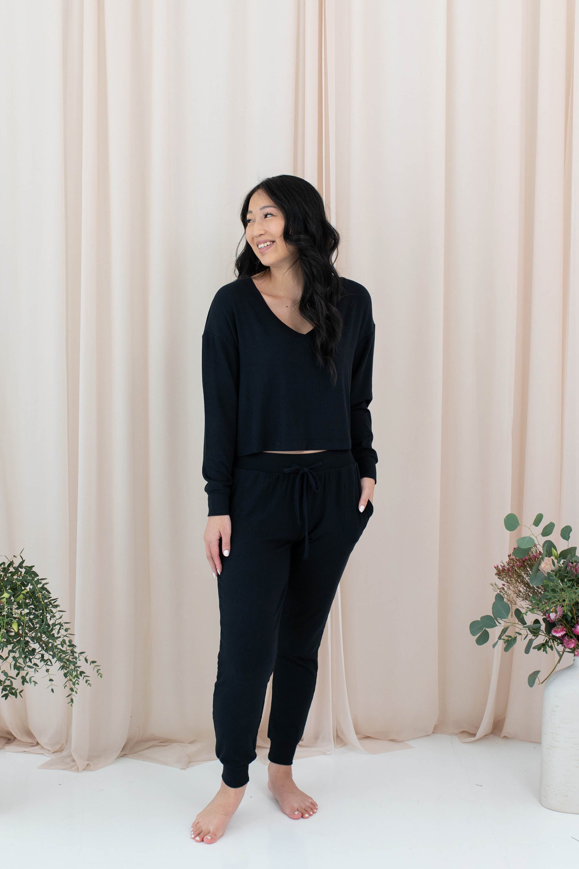 Model wearing the Women's Ribbed Long Sleeve Crop Top in Midnight and Midnight Jogger Pants
