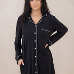 Woman with hand on hip modeling the Kyte Sleep Shirt in Midnight