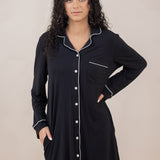 Woman with hand on hip modeling the Kyte Sleep Shirt in Midnight