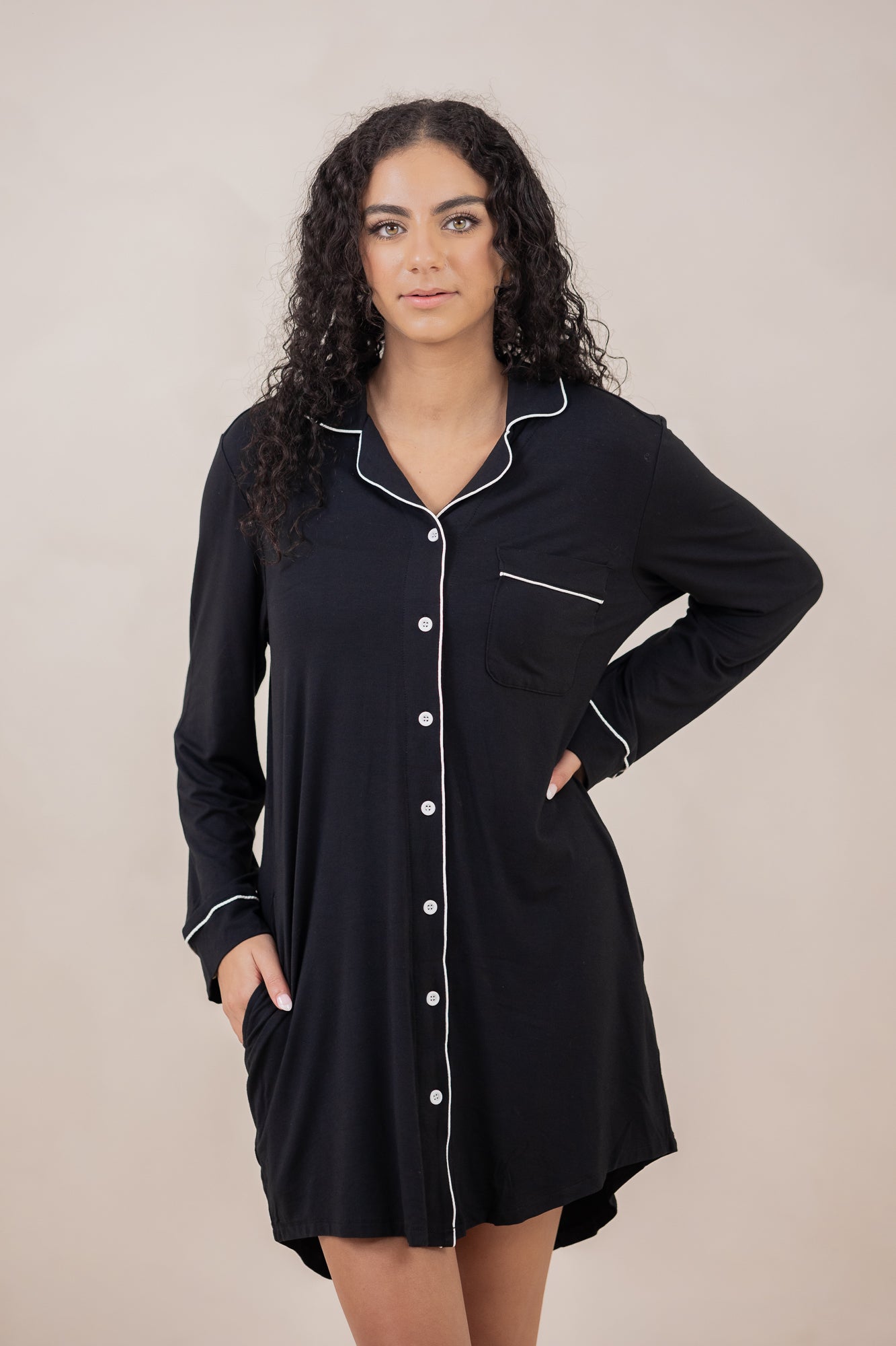 Woman with hand on hip modeling the Kyte Sleep Shirt in Midnight