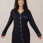 Woman smiling with arms to the side modeling the  Women's Sleep Shirt in Midnight