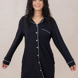 Woman smiling with arms to the side modeling the  Women's Sleep Shirt in Midnight