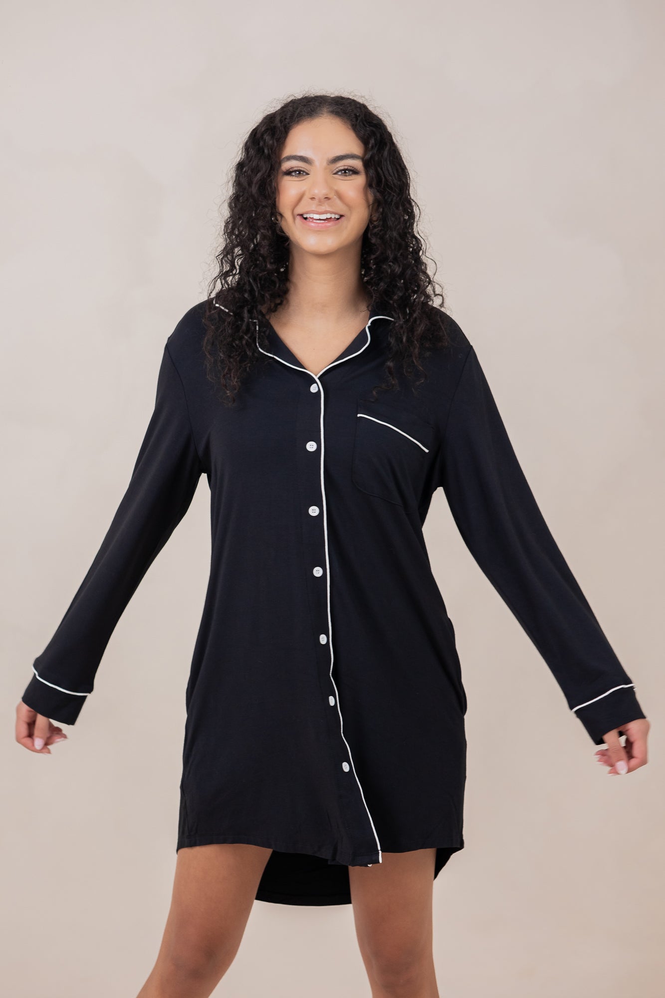 Woman smiling with arms to the side modeling the  Women's Sleep Shirt in Midnight