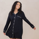 Model wearing the Sleep Shirt in Midnight with one arm holding hem and other arm out to the side